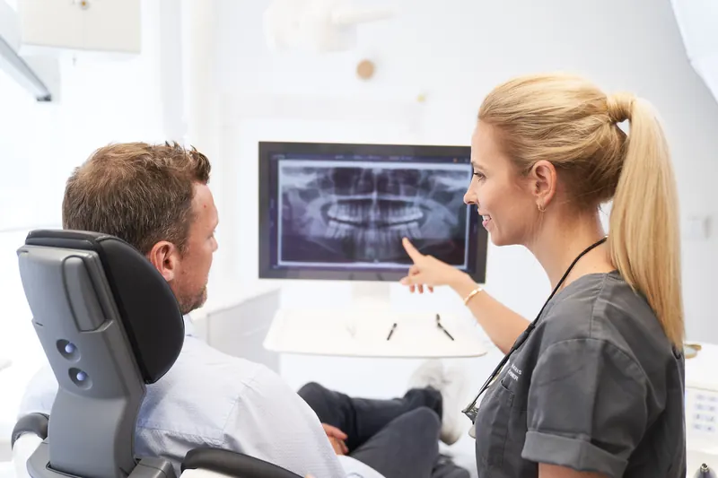 Dentist discussing an X-ray with a patient